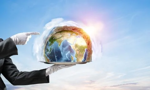 Hand of waitress presenting Earth globe on tray. Stock Photos