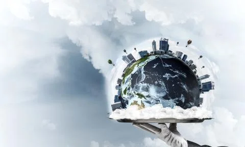 Hand of waitress presenting Earth globe on tray. Stock Photos