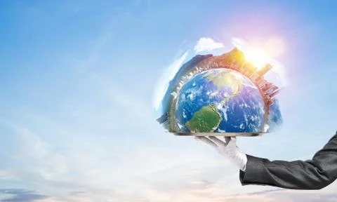 Hand of waitress presenting Earth globe on tray. Stock Photos
