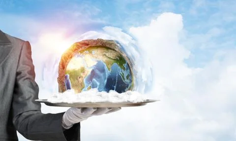 Hand of waitress presenting Earth globe on tray. Stock Photos