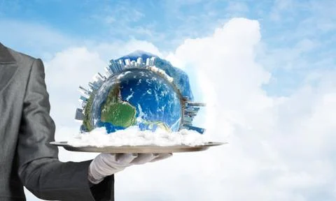 Hand of waitress presenting Earth globe on tray. Stock Photos