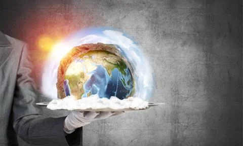 Hand of waitress presenting Earth globe on tray. Stock Photos