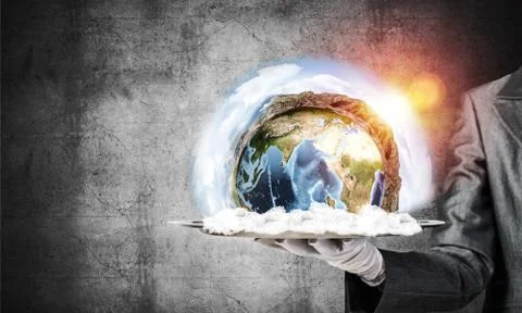 Hand of waitress presenting Earth globe on tray. Stock Photos