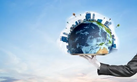 Hand of waitress presenting Earth globe on tray. Stock Photos