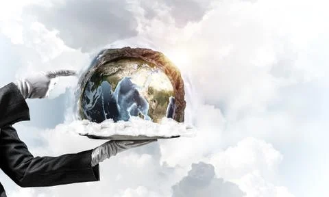 Hand of waitress presenting Earth globe on tray. Stock Photos
