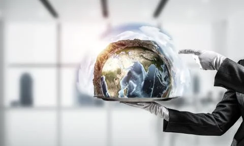 Hand of waitress presenting Earth globe on tray. Stock Photos