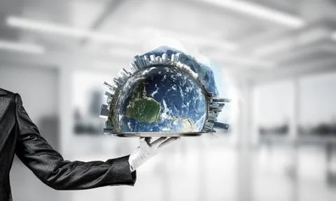Hand of waitress presenting Earth globe on tray. Stock Photos