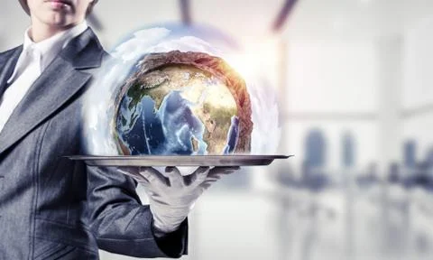 Hand of waitress presenting Earth globe on tray. Stock Photos
