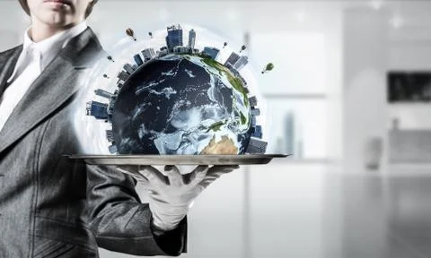 Hand of waitress presenting Earth globe on tray. Stock Photos