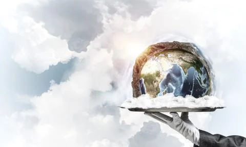 Hand of waitress presenting Earth globe on tray. Stock Photos