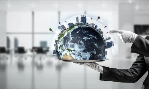 Hand of waitress presenting Earth globe on tray. Stock Photos
