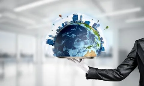 Hand of waitress presenting Earth globe on tray. Stock Photos