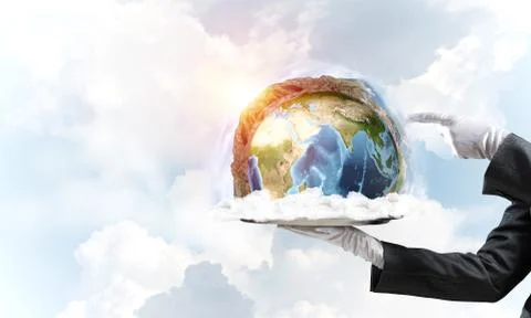 Hand of waitress presenting Earth globe on tray. Stock Photos