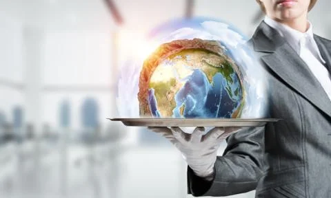 Hand of waitress presenting Earth globe on tray. Stock Photos