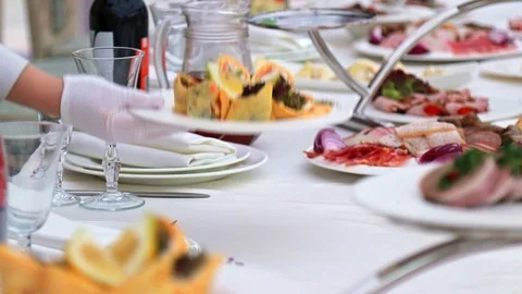 Hand waitress puts the dish on the table in a restaurant. Stock Footage 106060735
