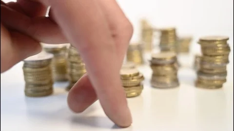 Hand walking between stacks of cents Stock Footage 127127351