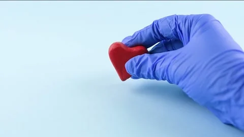 A hand  wards off a coronavirus model and puts a heart instead Stock Footage 145142642