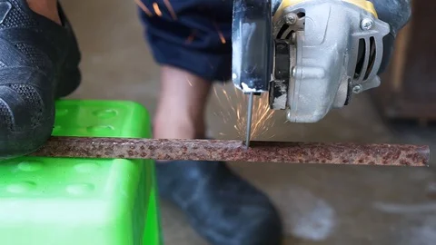 The hand was cutting iron using a grinder machine Stock Footage 127735066