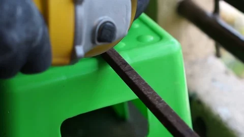 The hand was cutting iron using a grinder machine Stock Footage 127735138