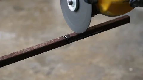 The hand was cutting iron using a grinder machine Stock Footage 127761843