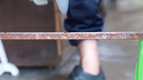 The hand was cutting iron using a grinder machine Stock Footage 127762223