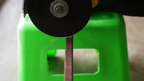 The hand was cutting iron using a grinder machine Stock Footage 127805292