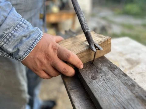 The hand that was holding a hammer to pull nail out. Stock Photos