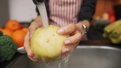 Hand wash the pears under running clean water. Concern about the purity of the Stock Footage 169437537