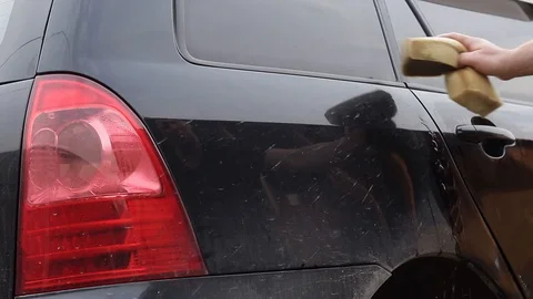 Hand washes a car. hand washes a car closeup. Stock Footage 129137474
