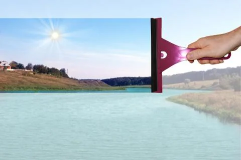 A hand washes a dirty window Stock Photos