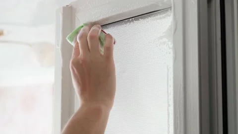 A hand washes plastic doors with opaque windows with a sponge with foamy Stock Footage 218449115