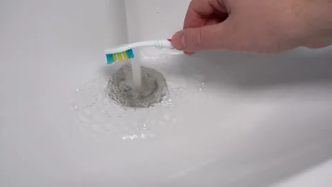 Hand Washes the Toothbrush from the Paste under the Pressure of Water Stock Footage 150455333