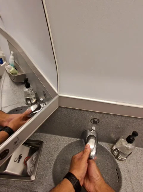 Hand Washing And Drying Up inside airline bathroom Stock Footage 306927217