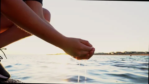 Hand washing at the beach on a sunset Stock Footage 161132164