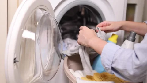 Hand washing children's clothes in soapy water with laundry detergent, gentle Stock Footage 345751596