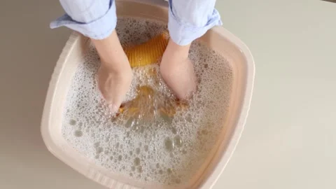 Hand washing children's clothes in soapy water with laundry detergent, gentle Stock Footage 345751671