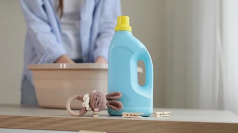 Hand washing children's clothes in soapy water with laundry detergent, gentle Stock Footage 345751702
