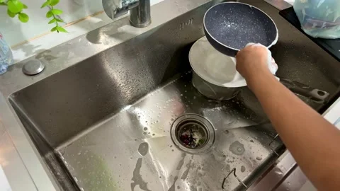 Hand washing dishes in kitchen sink close up, cleaning cookware, household Stock Footage 345289042