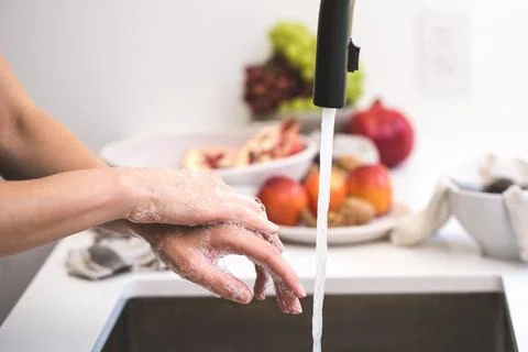 Hand-washing-in-the-kitchen   Stock Photos