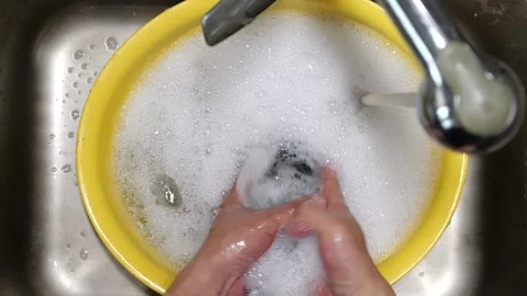 Hand-washing socks in a basin with bare hands. Stock Footage 332318247