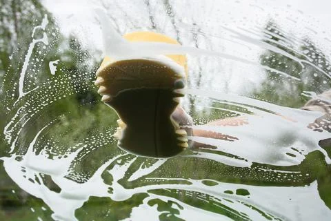 Hand washing window of car, inside view Stock Photos