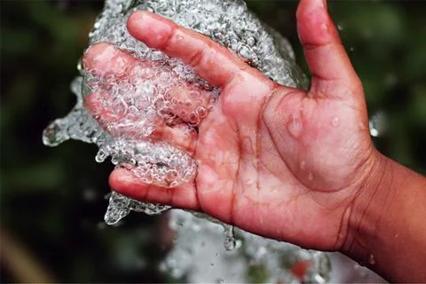 Hand in water Stock Photos
