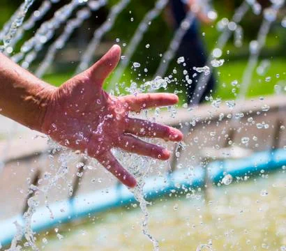 Hand on water splash background Stock Photos