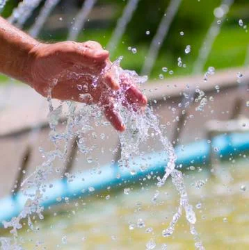 Hand on water splash background Stock Photos