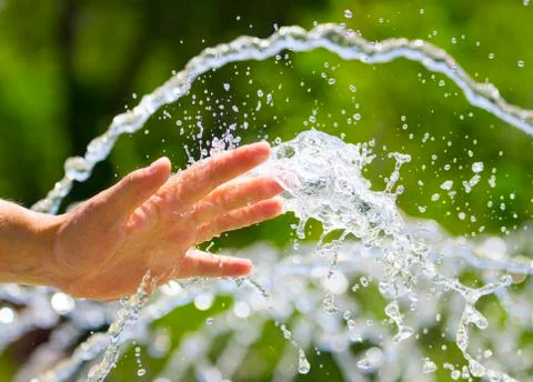 Hand on water splash background Stock Photos