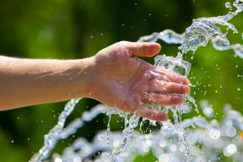 Hand on water splash background Stock Photos
