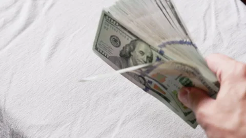 Hand waving large stack of paper money indoors Stock Footage 331516245