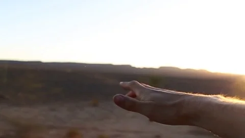 Hand waving outside car window in the desert Stock Footage