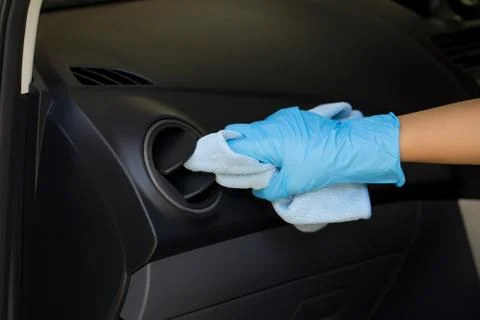 Hand wearing rubber gloves, using a microfiber cloth to clean and remove dust Stock Photos