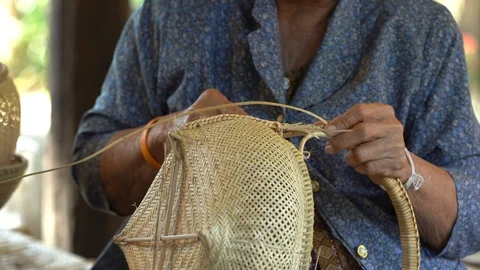 Hand weaving a bamboo basket Stock Footage